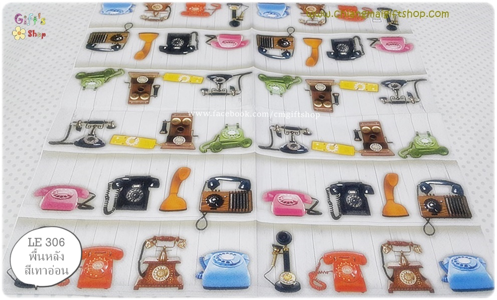 กระดาษแนปกิ้น ลายโทรศัพท์บ้านแบบเก่าหลายแบบ สีชมพู ดำ ส้ม น้ำตาล เขียว เหลือง ผนังไม้ด้านหลังสีเทาอ่อน พื้นหลังสีเทาอ่อน Give us a ring