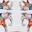 กระดาษแนปกิ้นยุโรป, ลายช้าง, ลายช้างใส่มงกุฎดอกไม้เพนท์ลายดอกไม้ที่ตัวหลายสี สีส้มชมพูเขียวน้ำเงิน ใบหูสีแดงชมพู, พื้นหลังสีขาว
